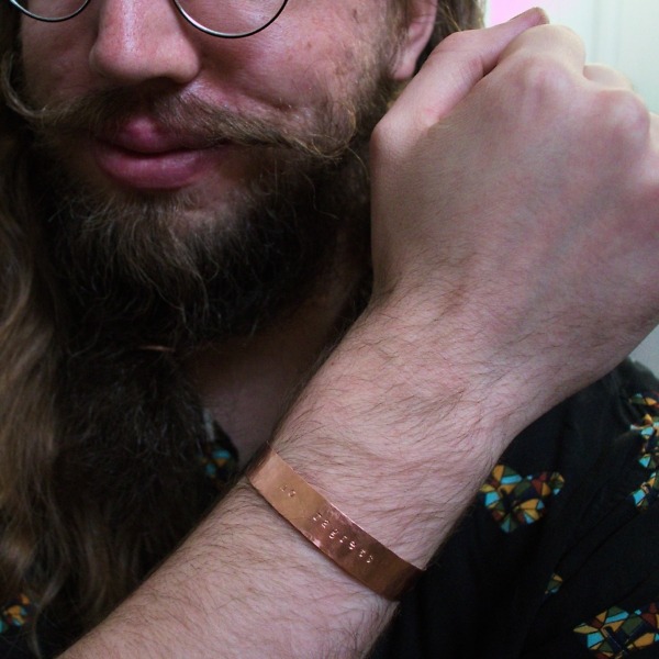 no ragrets – custom stamped copper bracelet – in use – fist in air (4)-2 (RR)